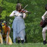 Reanna Roane, left, creeps out of the woods as she joins an all-female cast of 13 actors, musicians and dancers (Kathy Willens / AP)